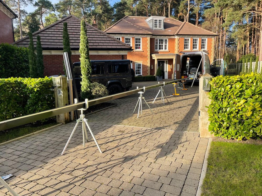 Seamless guttering being rolled to length on a driveway